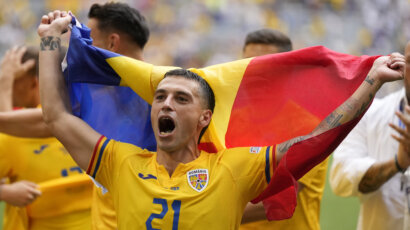 Romania cruise to victory in Group E opener