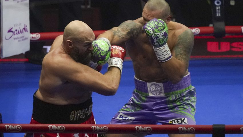 Oleksandr Usyk blocks Tyson Fury in a heated rematch for the world heavyweight title