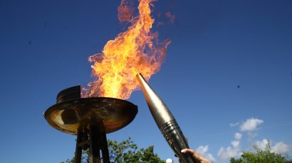Rain forces Milano Games torch ceremony indoors